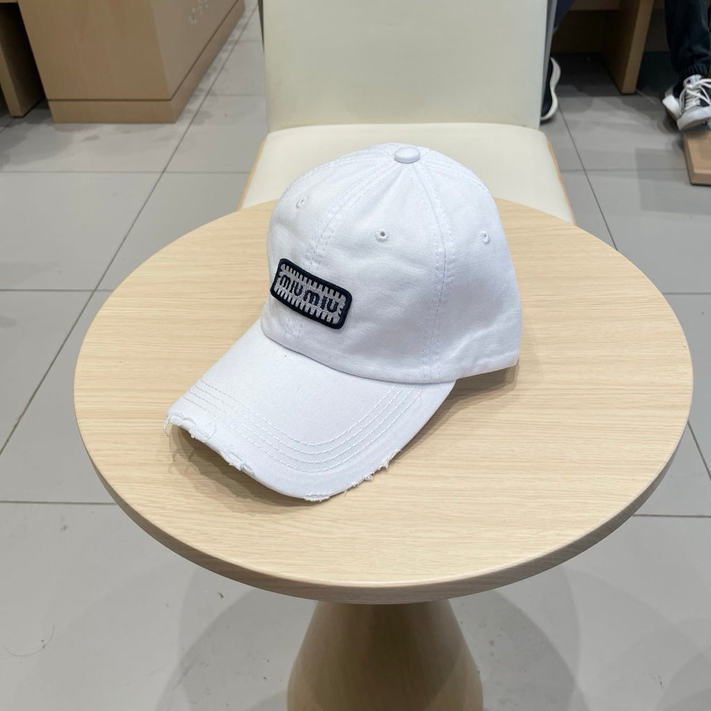 MIU MIU MM DISTRESSED FABRIC BASEBALL CAP IN WHITE WITH EMBROIDERED LOGO
